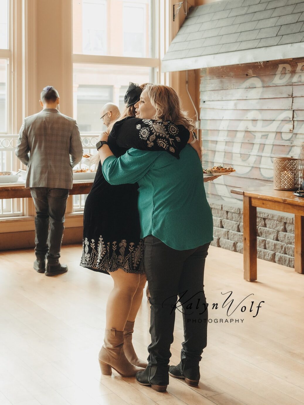 Michelle Tverberg gives a hug to a fellow wedding vendor