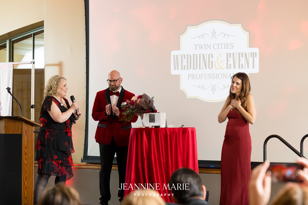 Michelle Tverberg, Matthew Sherry, and Elizabeth Sherry on stage at the TCWEP Red Gala