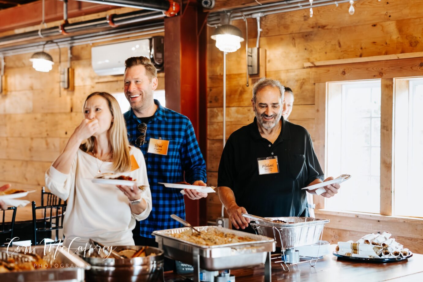Happy event attendees enjoying Big Guys BBQ Roadhouse catering at a wedding event